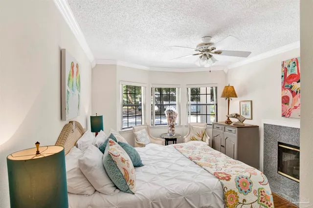 a bedroom with a bed dresser and window