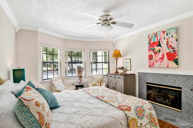 a bedroom with a bed a dresser next to a window