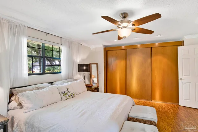 a bedroom with a bed and a large window