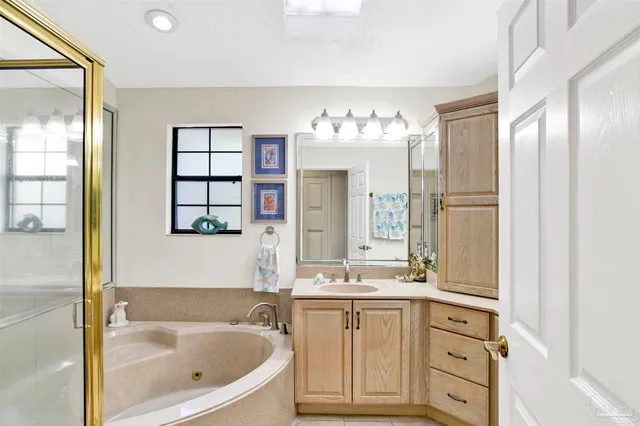 a bathroom with a tub sink and mirror