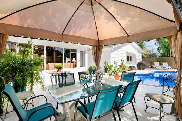 a view of a patio with table and chairs potted plants with wooden floor