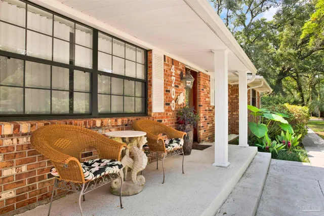 a balcony with furniture and potted plants
