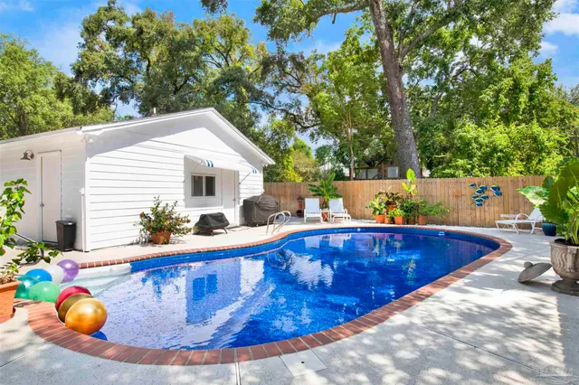 a view of a swimming pool with chairs