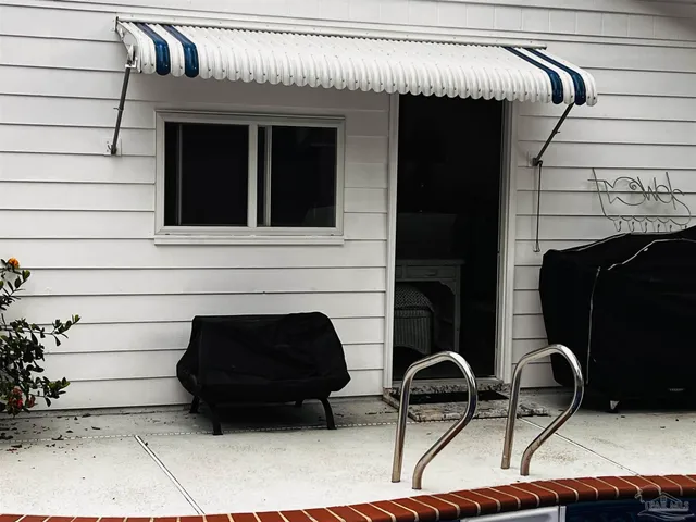 a white house with a tree in the background