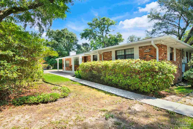 a view of a house with backyard and porch