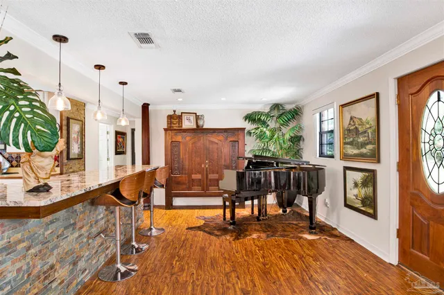 a living room with furniture a large window with wooden floor