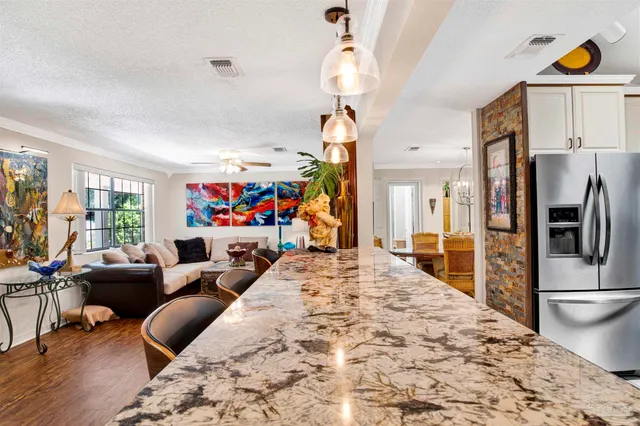 a bedroom with a bed furniture and a flat screen tv
