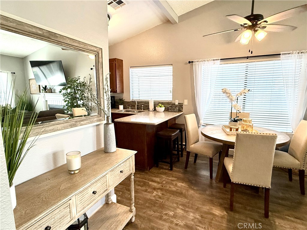 377 Quandt Ranch Road San Jacinto, CA 92583 - Photo 18 of 37 a view of a kitchen area kitchen island dining table and chairs