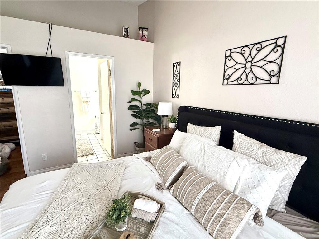 377 Quandt Ranch Road San Jacinto, CA 92583 - Photo 22 of 37 a bedroom with a bed and a painting on the wall