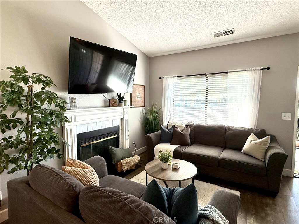 377 Quandt Ranch Road San Jacinto, CA 92583 - Photo 4 of 37 a living room with furniture fireplace and flat screen tv