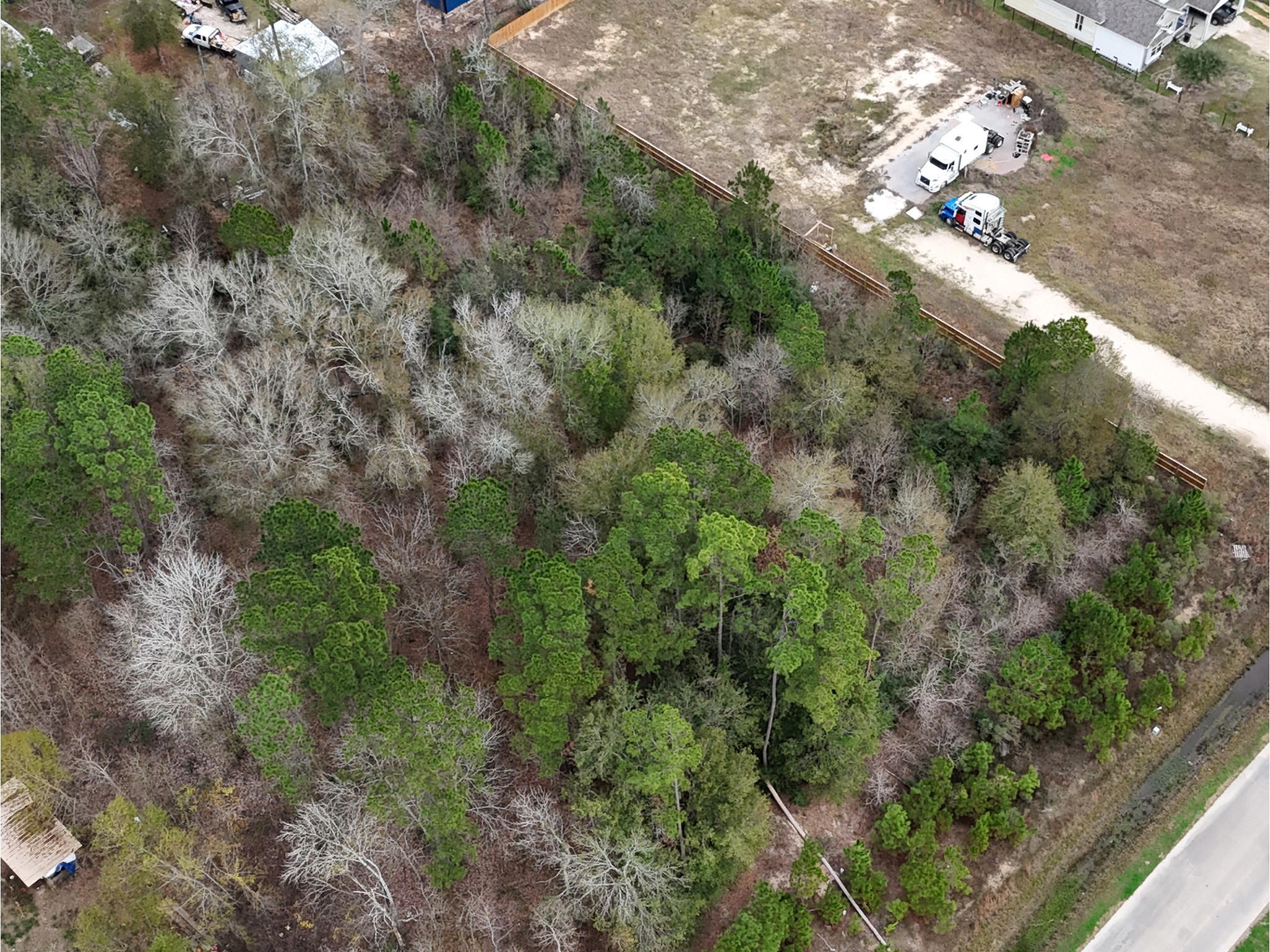 1798 County Road 5007 Cleveland, TX 77327 - Photo 3 of 3 a view of a city with lush green forest