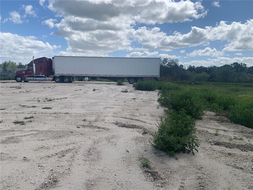 0 Rhino Road Lakeland, FL 33801 - Photo 2 of 9 a view of a dry yard with wooden fence