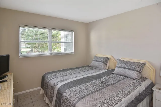 a bedroom with a bed and flat screen tv