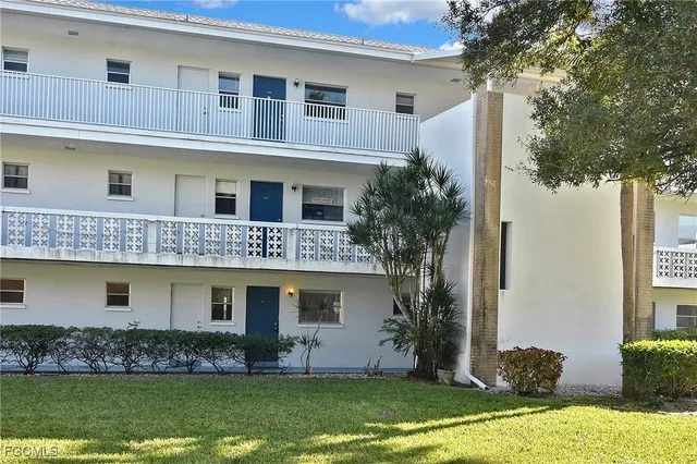 a front view of house with yard and swimming pool