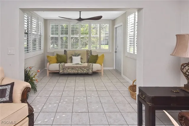 a living room with furniture and a floor to ceiling window