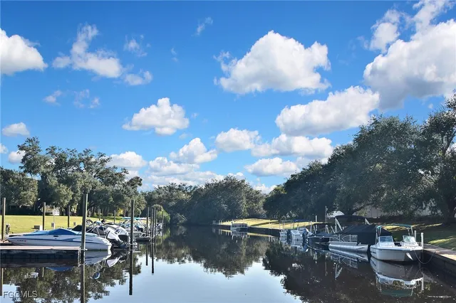 a view of a lake with lawn chairs