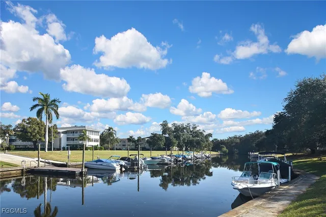a roof deck view with lawn chairs plants and lake view