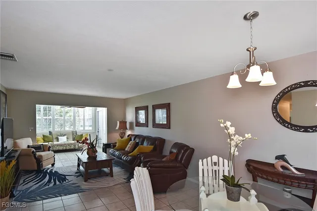 a living room with furniture a window and a chandelier