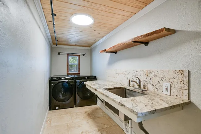 a kitchen with a stove a sink and a refrigerator