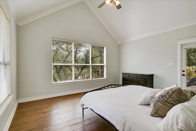 a bedroom with a large bed and a window
