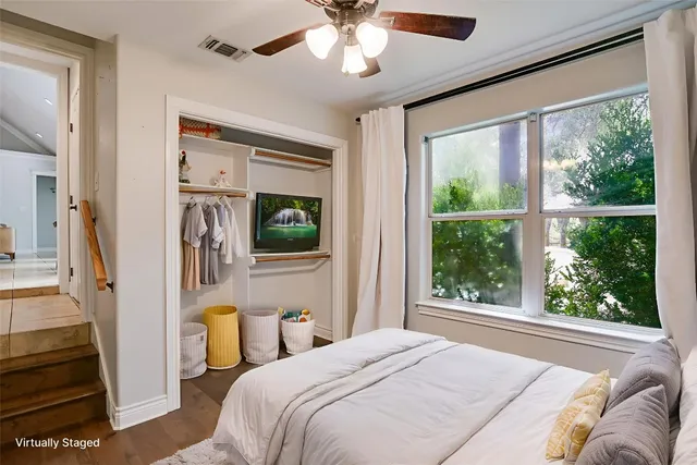 a bedroom with a bed a window and couch