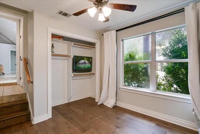 wooden floor in an empty room with a window