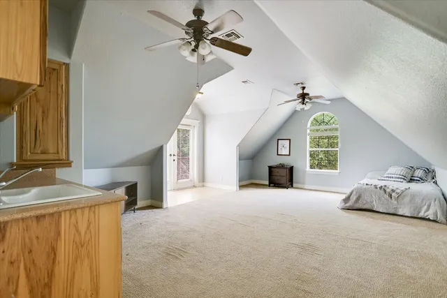 a view of a livingroom with a fireplace a ceiling fan and a fireplace