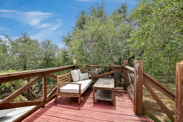 a view of a balcony with wooden floor and bench