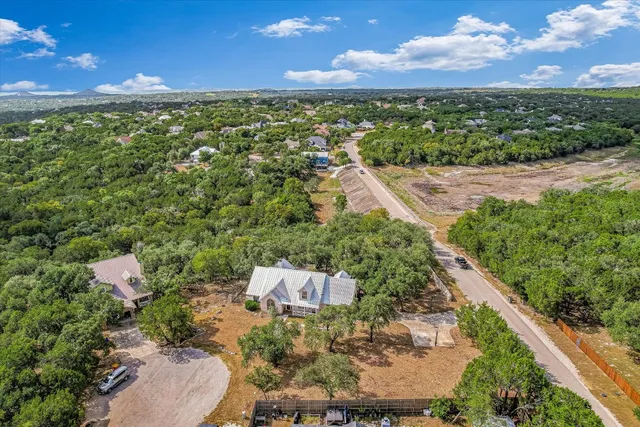 an aerial view of a house with a yard