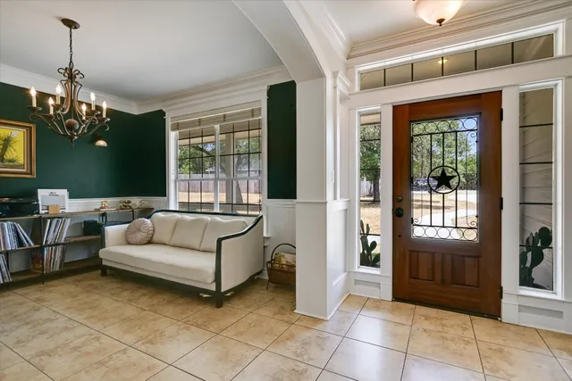 a living room with furniture and a chandelier