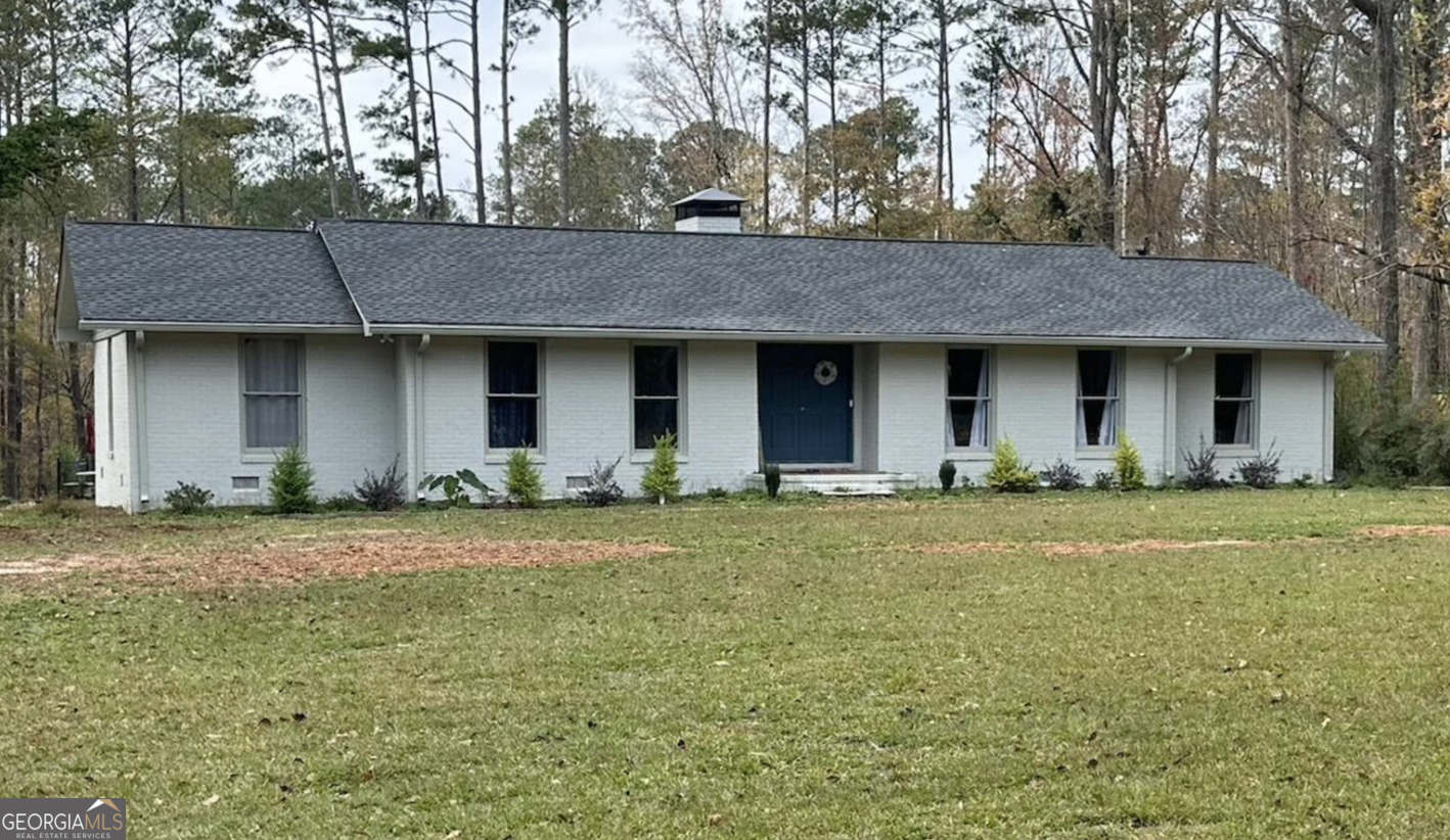 a front view of house with yard and trees