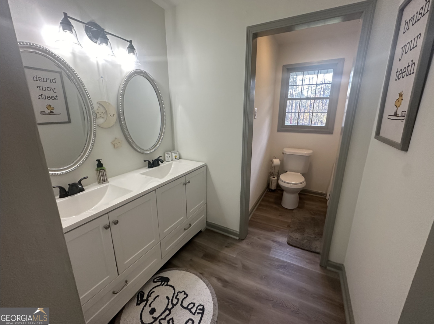 2775 Jackson Road Griffin, GA 30223 - Photo 15 of 30 a bathroom with a toilet sink and mirror