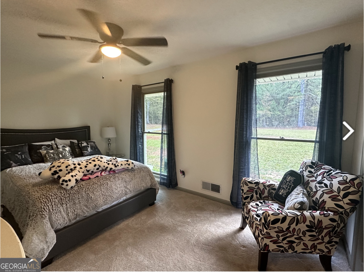 2775 Jackson Road Griffin, GA 30223 - Photo 18 of 30 a bedroom with a bed and a chandelier