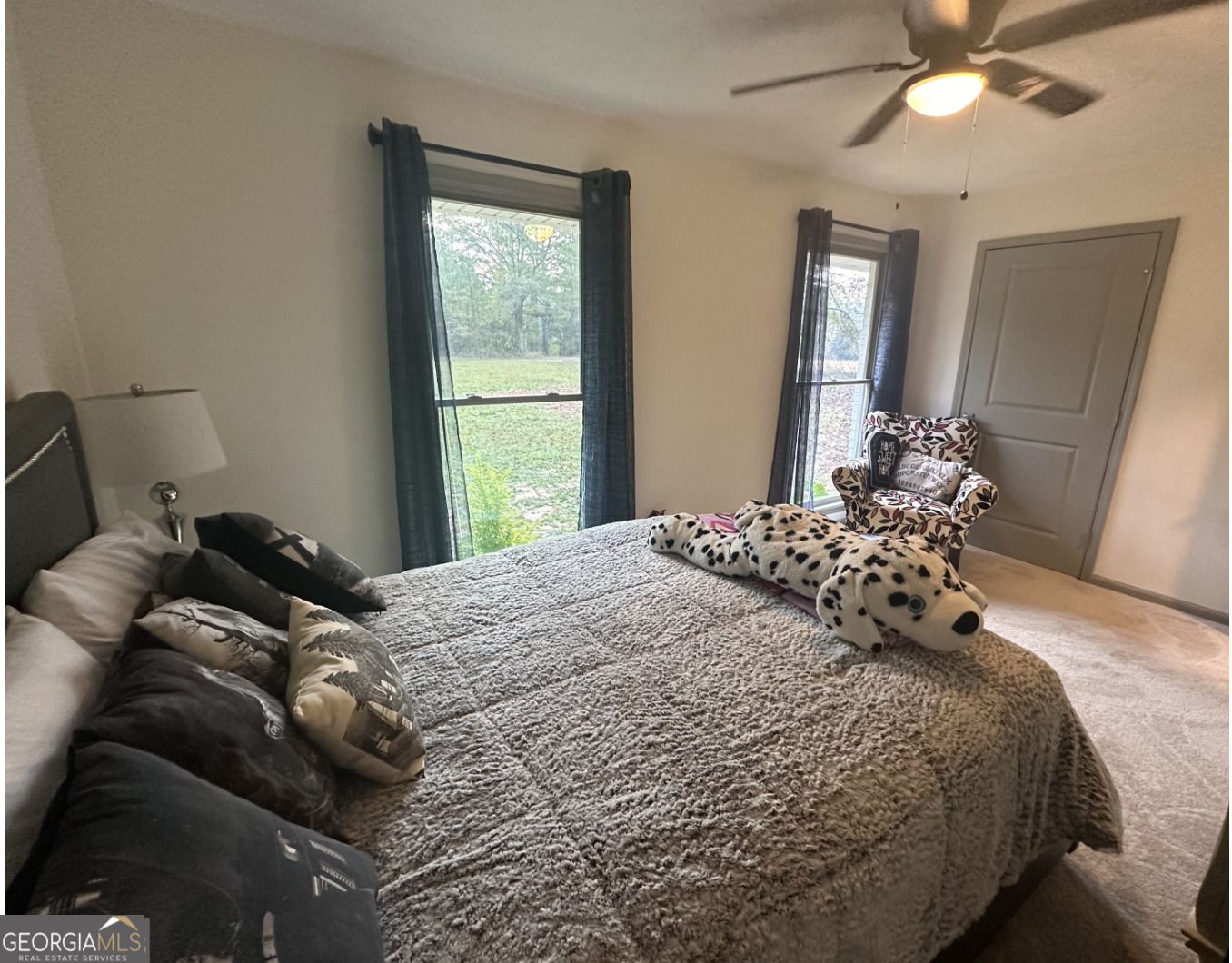 2775 Jackson Road Griffin, GA 30223 - Photo 19 of 30 a bedroom with a bed and a chandelier