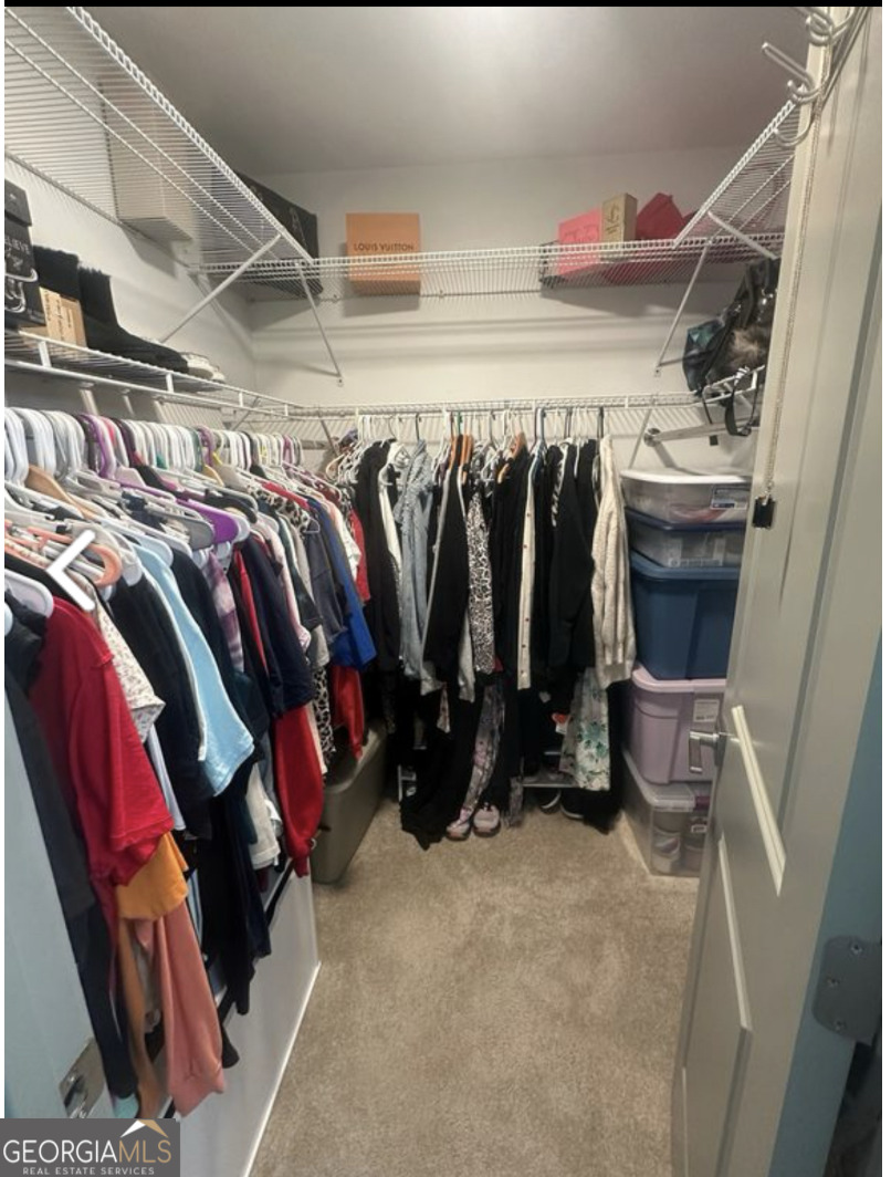 2775 Jackson Road Griffin, GA 30223 - Photo 23 of 30 a view of walk in closet with clothes and shoes