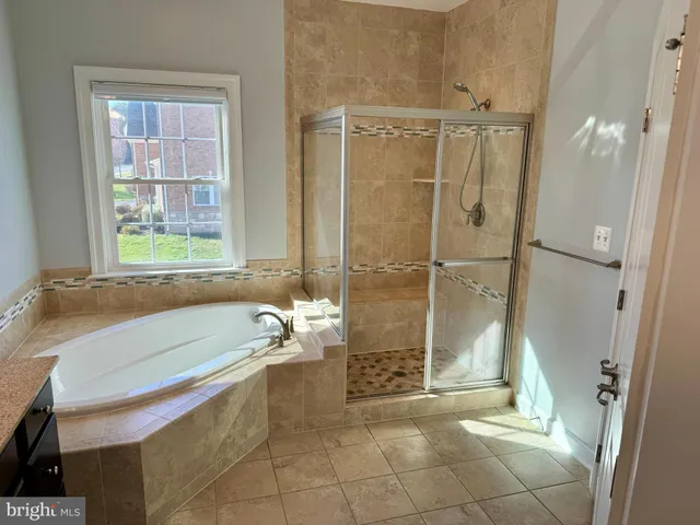 a bathroom with a bathtub and a shower