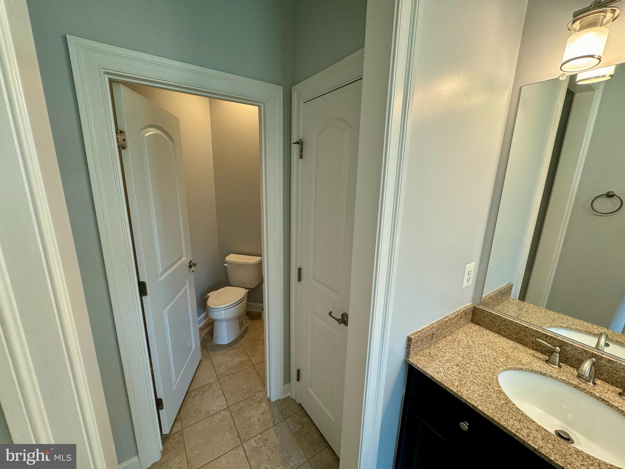 42403 Pine Forest Drive Chantilly, VA 20152 - Photo 16 of 37 a bathroom with a granite countertop sink toilet and shower a mirror