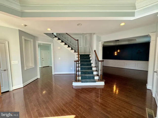 a view of entryway and hall with wooden floor