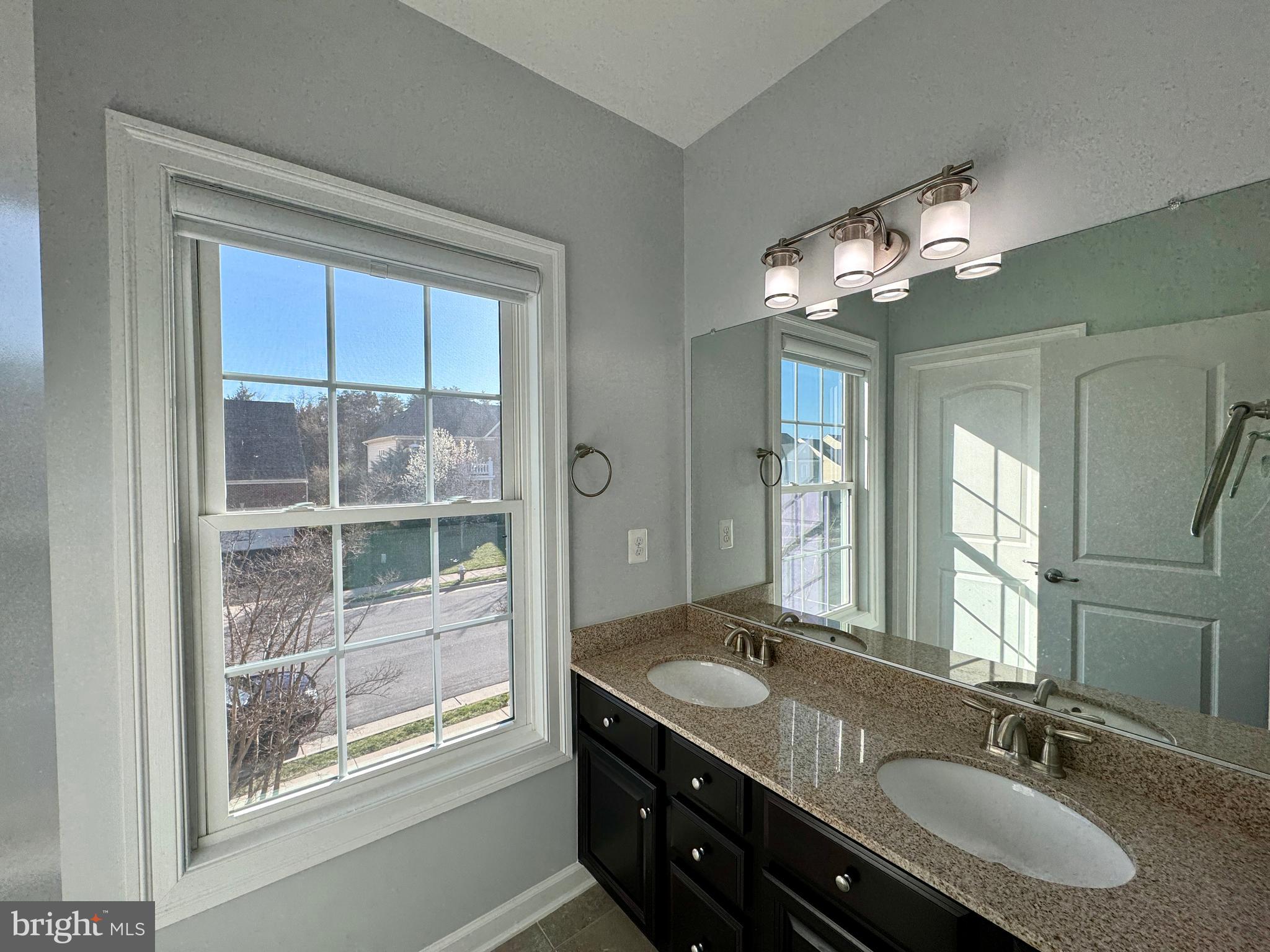 42403 Pine Forest Drive Chantilly, VA 20152 - Photo 25 of 37 a bathroom with double vanity and a mirror