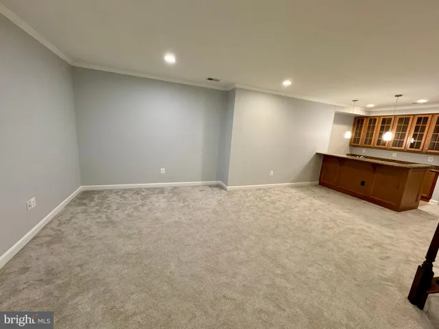 a room with granite countertop cabinets and window