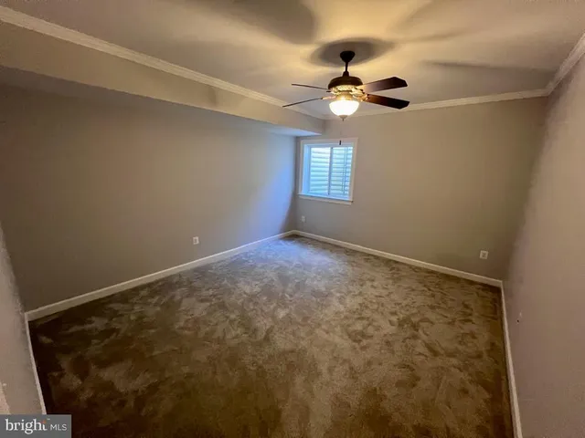 a view of a livingroom with a chandelier fan