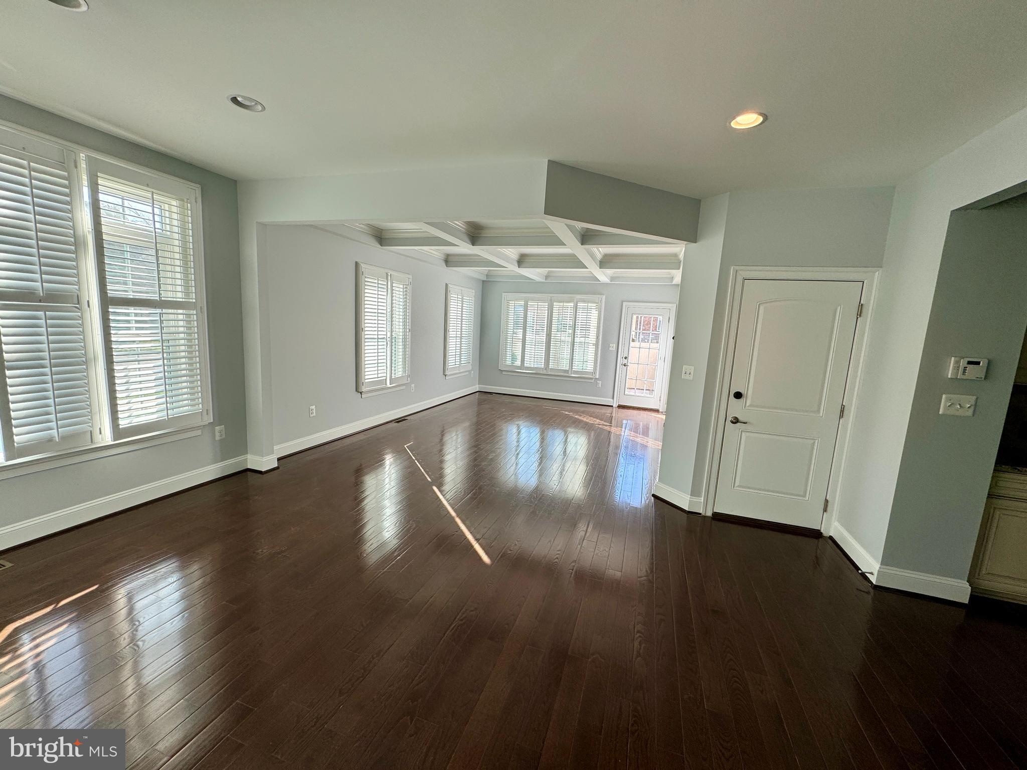 42403 Pine Forest Drive Chantilly, VA 20152 - Photo 3 of 37 an empty room with wooden floor and windows