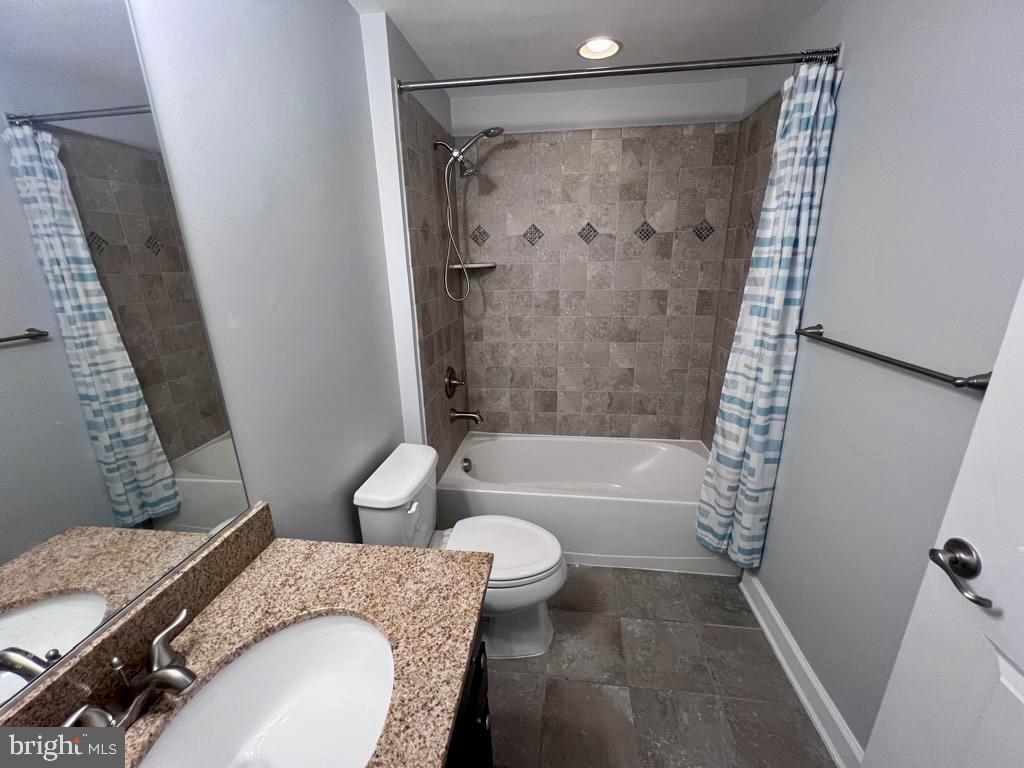 42403 Pine Forest Drive Chantilly, VA 20152 - Photo 32 of 37 a bathroom with a granite countertop bathtub shower sink vanity and toilet