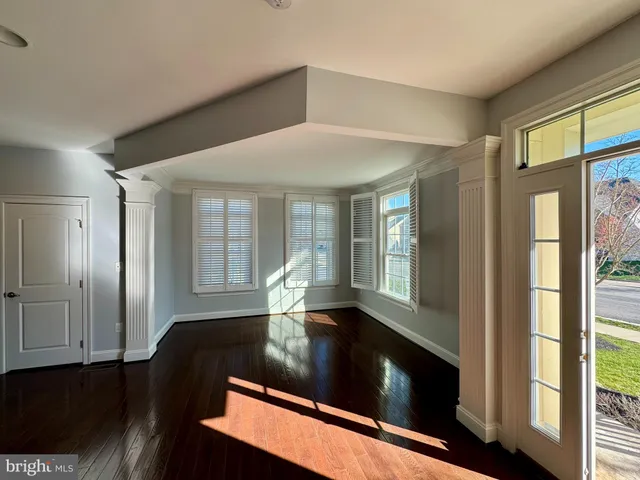 a view of an entryway with wooden floor
