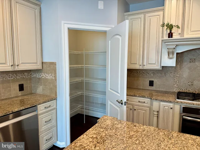 a kitchen with stainless steel appliances a stove a sink and a refrigerator