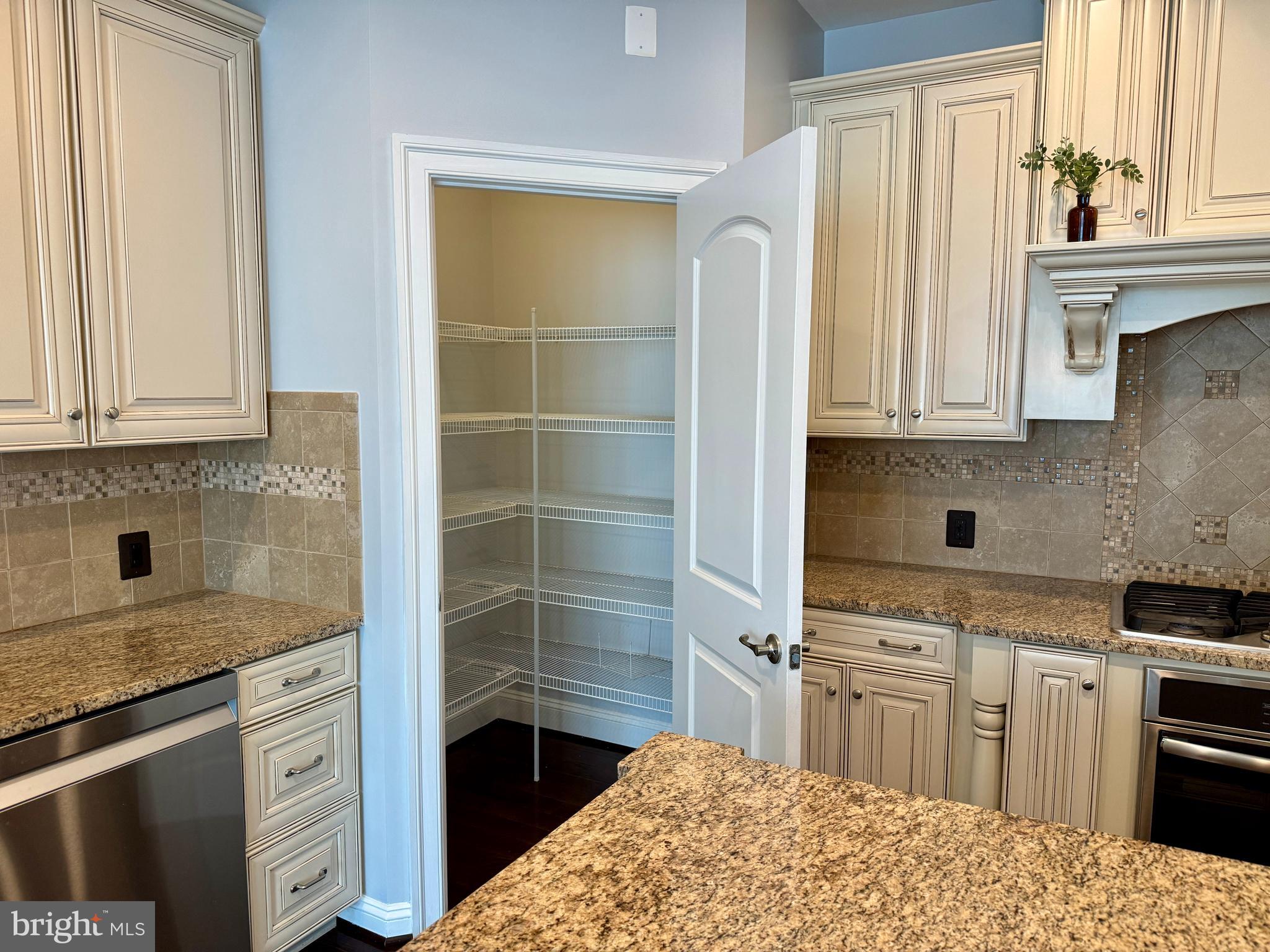 42403 Pine Forest Drive Chantilly, VA 20152 - Photo 8 of 37 a kitchen with stainless steel appliances a stove a sink and a refrigerator