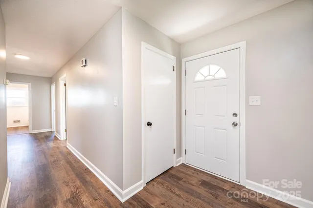 a view of hallway with wooden floor