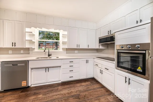 a kitchen with appliances cabinets and a sink