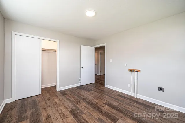 a view of a room with wooden floor and window
