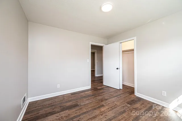 a view of an empty room and wooden floor